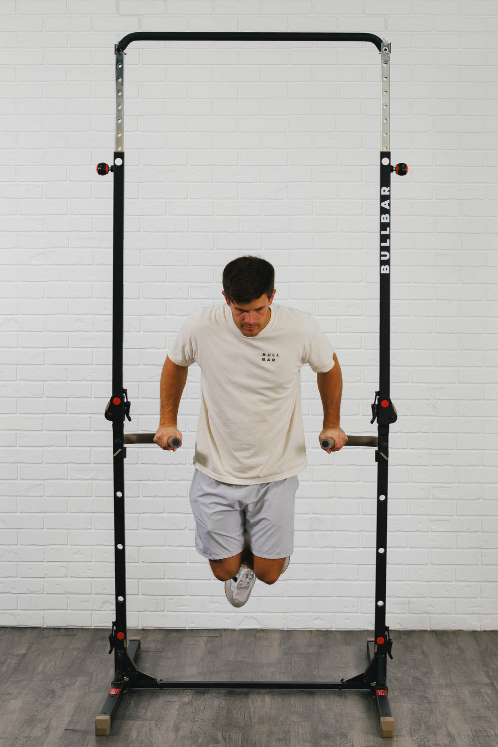 A man mid-dip on the BULLBAR dip bars, shoulders below elbows