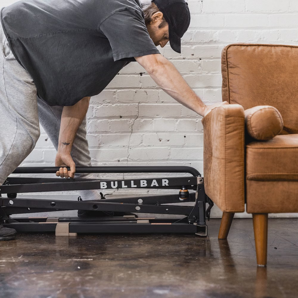 The folded BULLBAR slides under a couch for storage